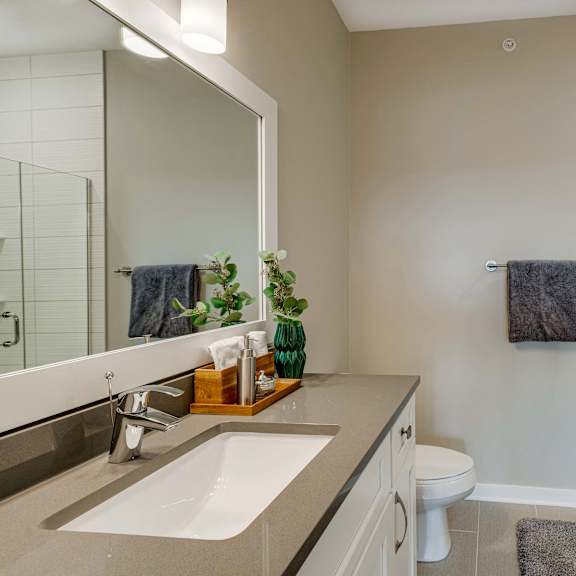 Thumbnail 14 of 19 Master bathroom with tile shower and quartz countertops in 2 bedroom apartment for rent at Ascend at Woodbury best apartments Woodbury MN 55129