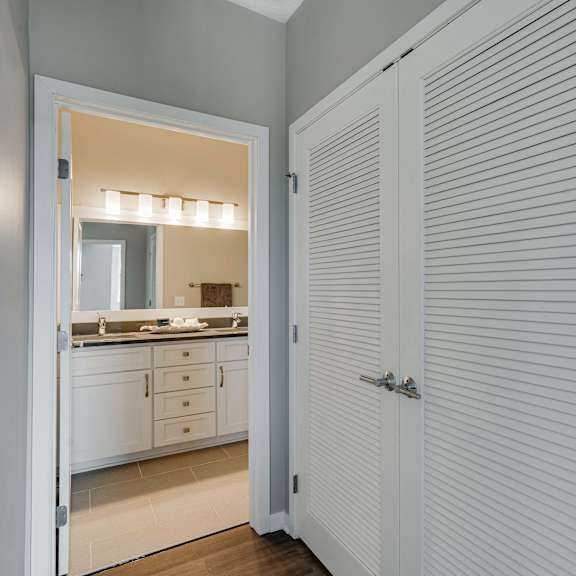 Thumbnail 18 of 19 View into bathroom and closet space at Ascend at Woodbury luxury apartments