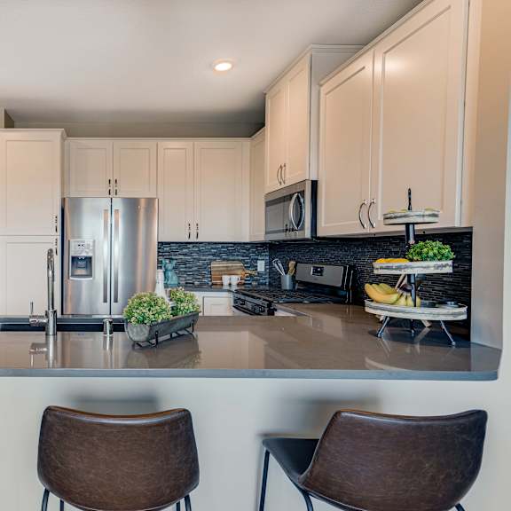 Thumbnail 8 of 19 kitchen with peninsula seating in premium white finish apartment