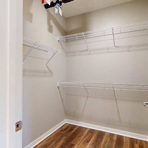 Thumbnail 3 of 13 An oversized walk-in closet with built-in wire shelves.