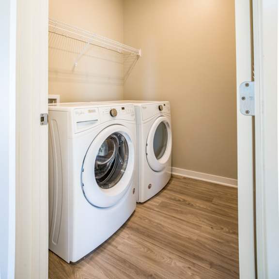 Thumbnail 10 of 12 A laundry room with a washer and dryer.