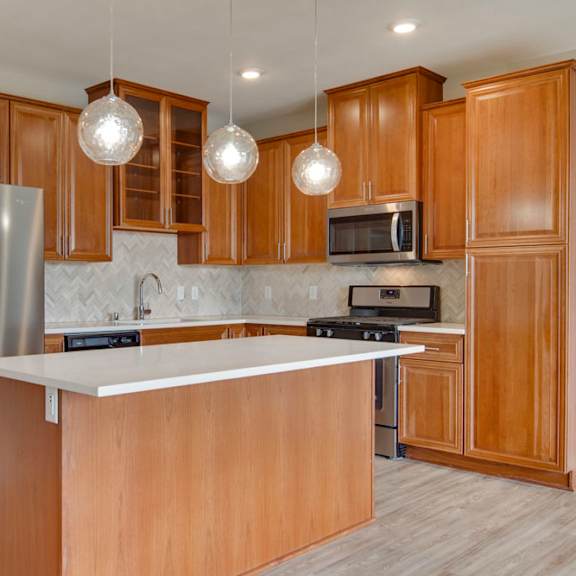 Thumbnail 6 of 12 Kitchen with large island and premium stainless steel appliances