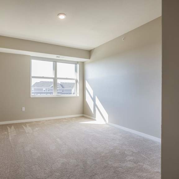Thumbnail 8 of 12 A bedroom with a window and carpeted floor.