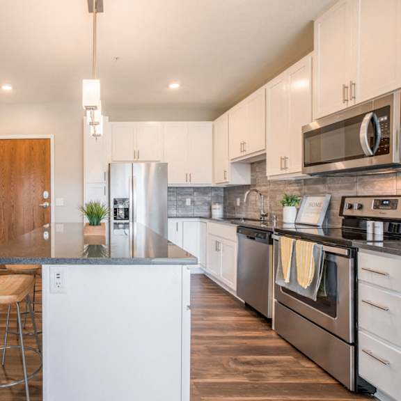 Thumbnail 9 of 12 Alpine design scheme kitchen with white cabinets at Ascend at Woodbury new luxury apartments in Woodbury MN 55129