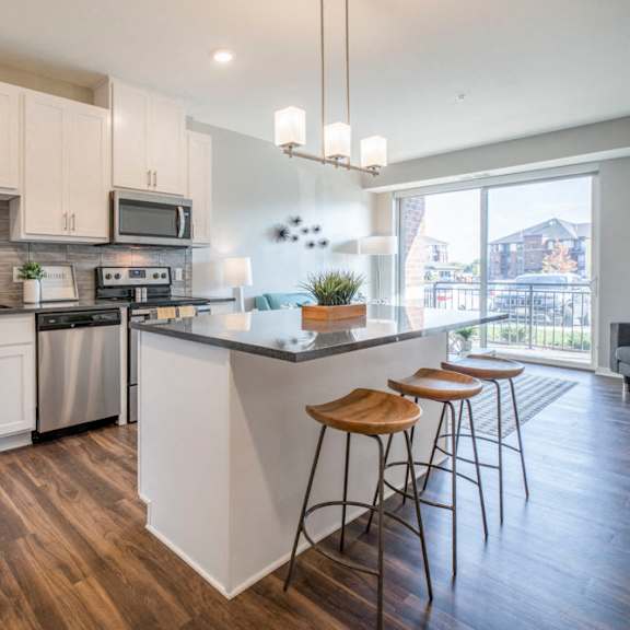 Thumbnail 3 of 12 Kitchen with pendant lighting and island at Ascend at Woodbury new luxury apartments in Woodbury MN 55129