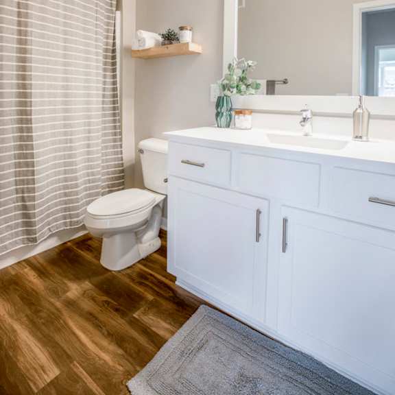 Thumbnail 10 of 12 Bathroom with white cabinetry at Ascend at Woodbury new luxury apartments in Woodbury MN 55129