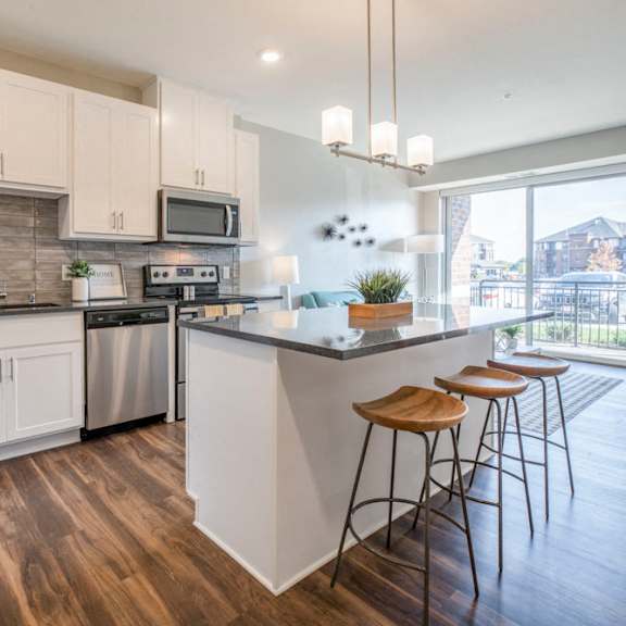 Thumbnail 3 of 12 Kitchen with pendant lighting and island at Ascend at Woodbury new luxury apartments in Woodbury MN 55129