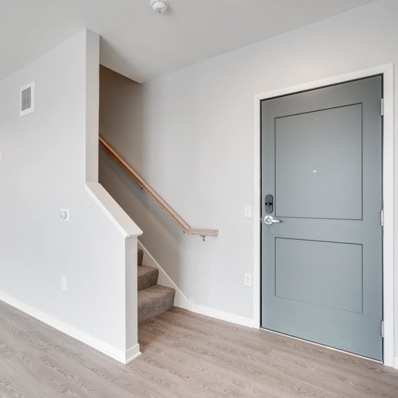 Thumbnail 9 of 16 Entryway and carpeted staircase leading to second floor at Aspire at CityPlace in Woodbury, Minnesota