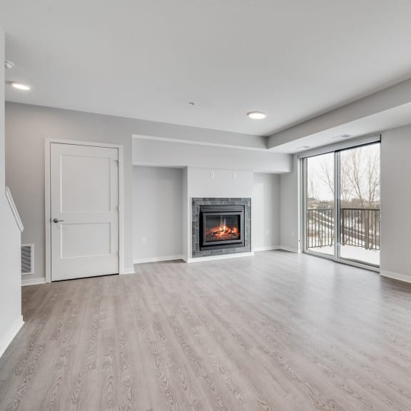 Thumbnail 6 of 16 Spacious living and dining area with luxury electric fireplace and a lot of natural light at Aspire at CityPlace in Woodbury, Minnesota