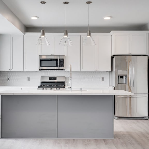 Thumbnail 3 of 16 Beautiful kitchen with light luxury finishes, matching stainless steel appliances, and granite countertops