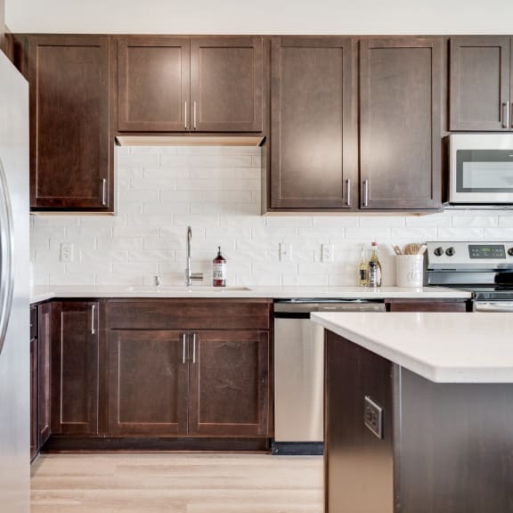 Thumbnail 3 of 13 1 bedroom luxury apartment kitchen with dark brown cabinets in Woodbury MN 55125