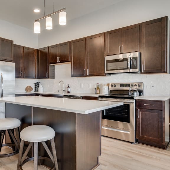 Thumbnail 4 of 13 Luxury kitchen with white cabinets and an island at Aspire at CityPlace in Woodbury MN 55125