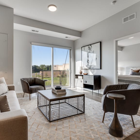 Thumbnail 7 of 13 Living space with warm brown floors in luxury apartment Woodbury MN 55125