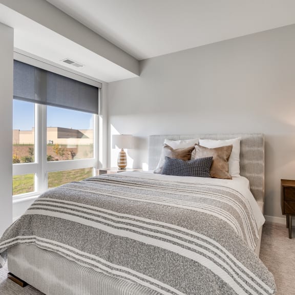 Thumbnail 9 of 13 Large bedroom with floor to ceiling window in luxury apartment in Woodbury MN 55125