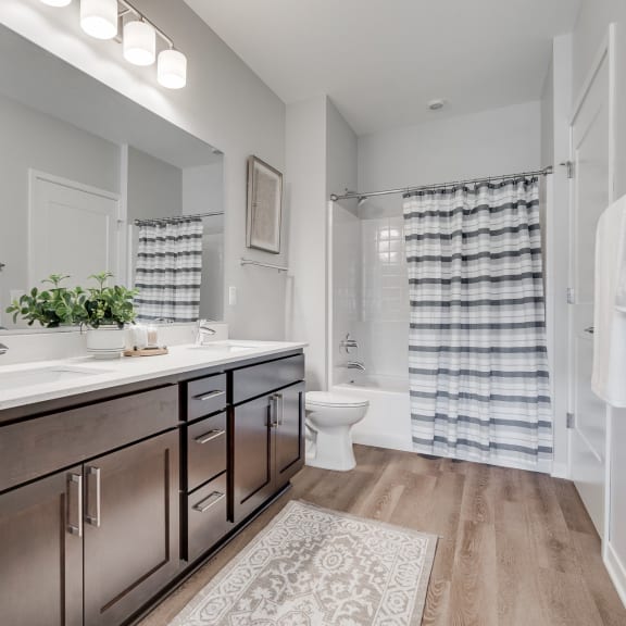 Thumbnail 11 of 13 Spacious bathroom with dual vanities and lots of storage in luxury apartment in Woodbury MN 55125