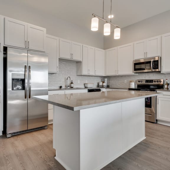 Thumbnail 2 of 15 Luxury kitchen with white cabinets and an island at Aspire at CityPlace in Woodbury MN 55125