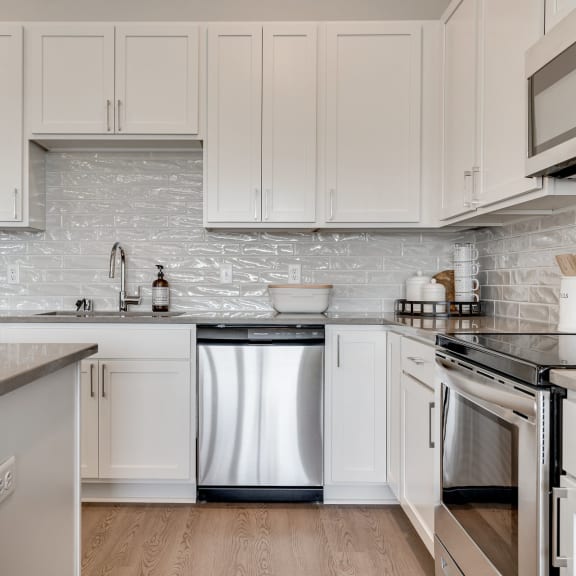Thumbnail 3 of 15 Luxury kitchen with white cabinets and an island at Aspire at CityPlace in Woodbury MN 55125