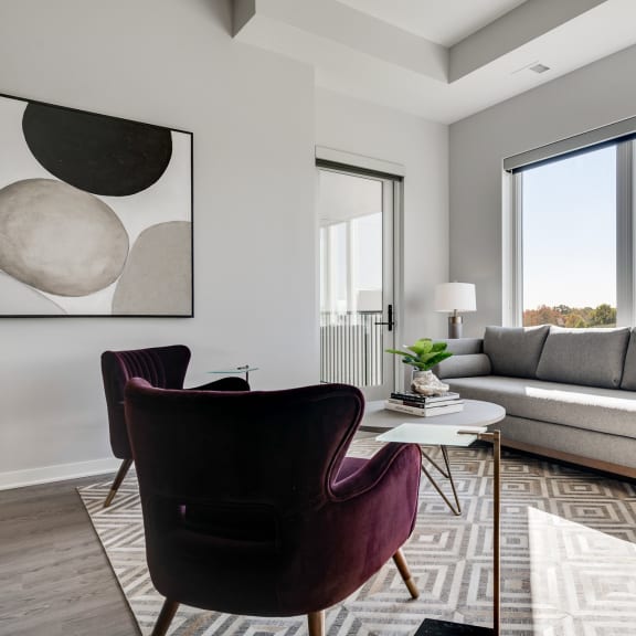 Thumbnail 7 of 15 Furnished living room with high ceilings and large windows at Aspire at CityPlace Woodbury MN 55125