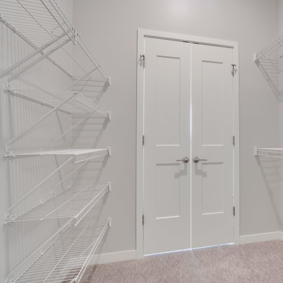Thumbnail 13 of 15 Large walk in closet with double doors and wire shelves on each side in 2 bedroom apartment in Woodbury MN 55125