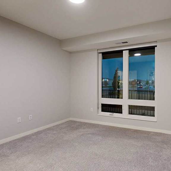 Thumbnail 19 of 19 A room with a window overlooking a cityscape.