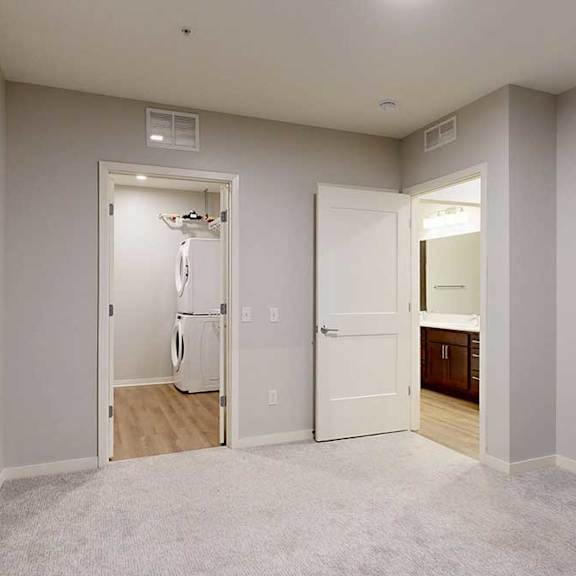 Thumbnail 8 of 19 A room with a white door and a white wall.