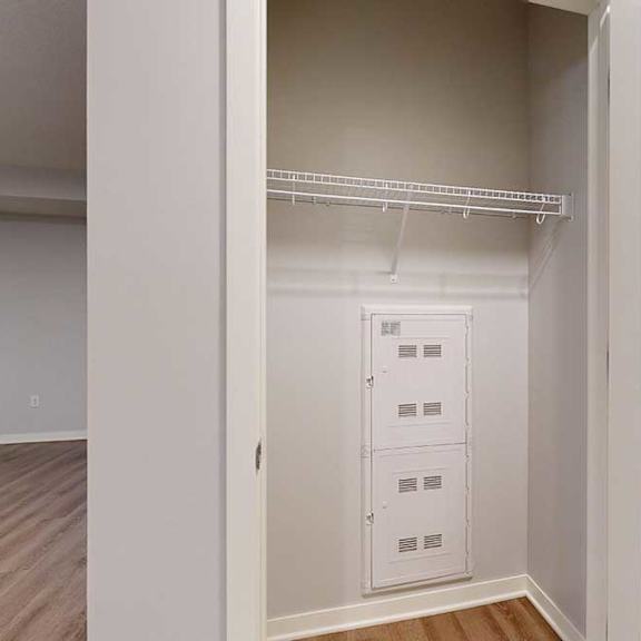 Thumbnail 2 of 19 A white closet with a shelf and a white door.