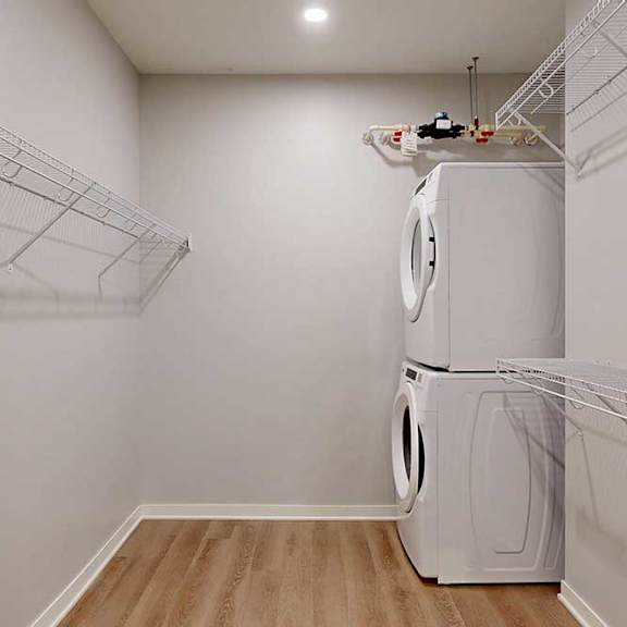 Thumbnail 18 of 19 A white laundry room with a washer and dryer.