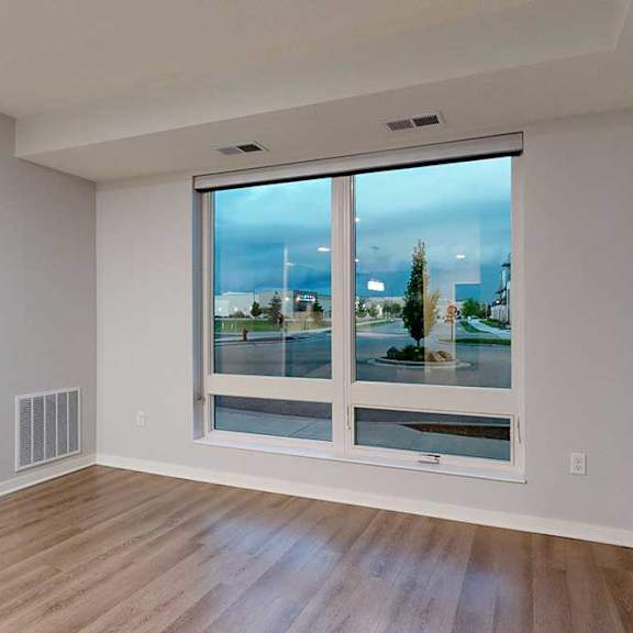 Thumbnail 11 of 19 A room with a large window overlooking a cityscape.