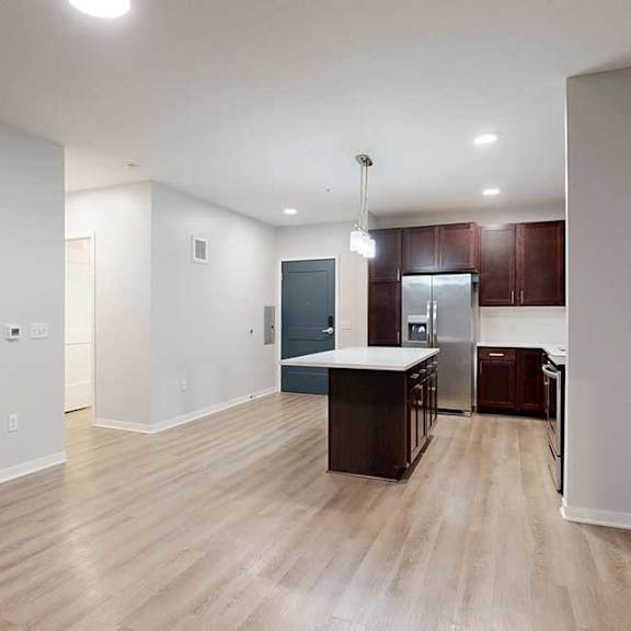 Thumbnail 15 of 19 A kitchen area with a counter and cabinets.