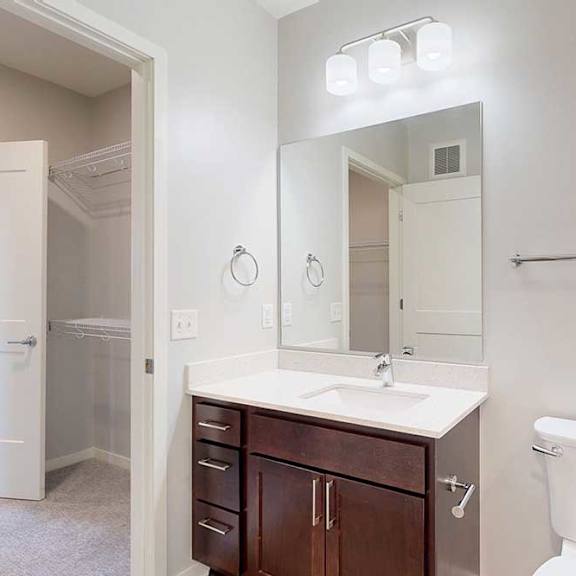 Thumbnail 24 of 27 A white toilet sits next to a sink in a bathroom.