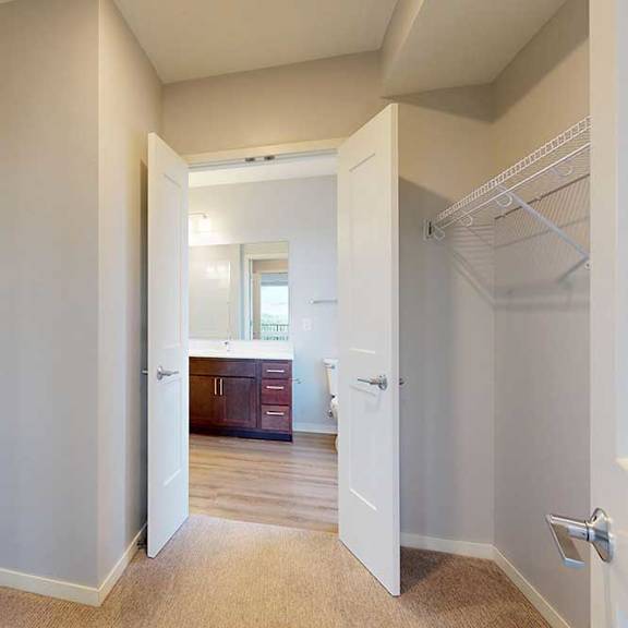 Thumbnail 5 of 27 A white pantry with a white door and a white fridge.