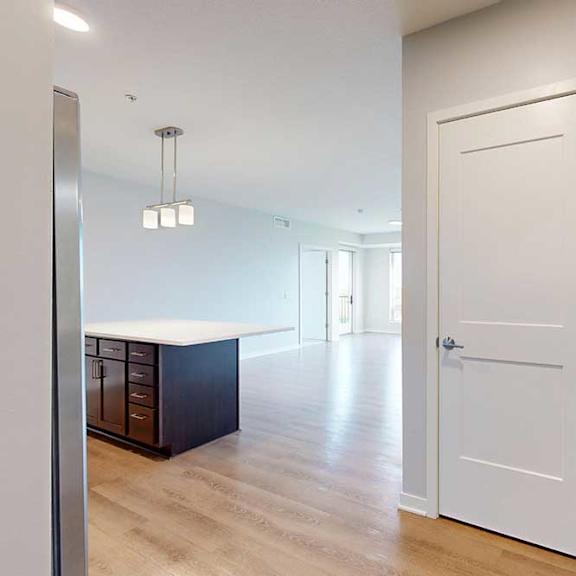 Thumbnail 2 of 27 A white door is in a hallway with a light on the ceiling.