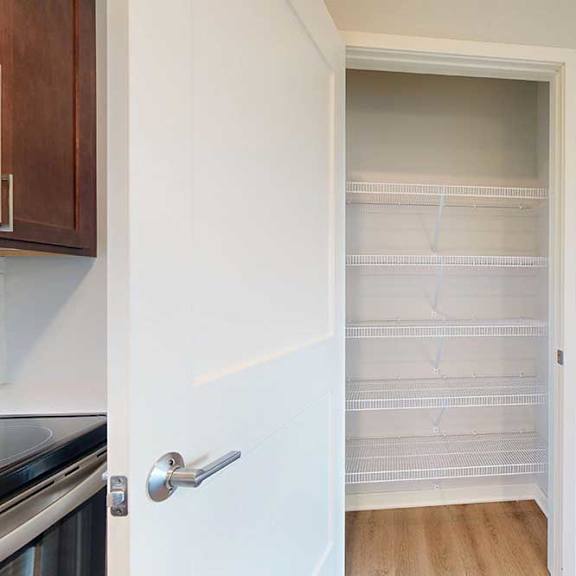 Thumbnail 25 of 27 A white door with a silver handle is open to a hallway.