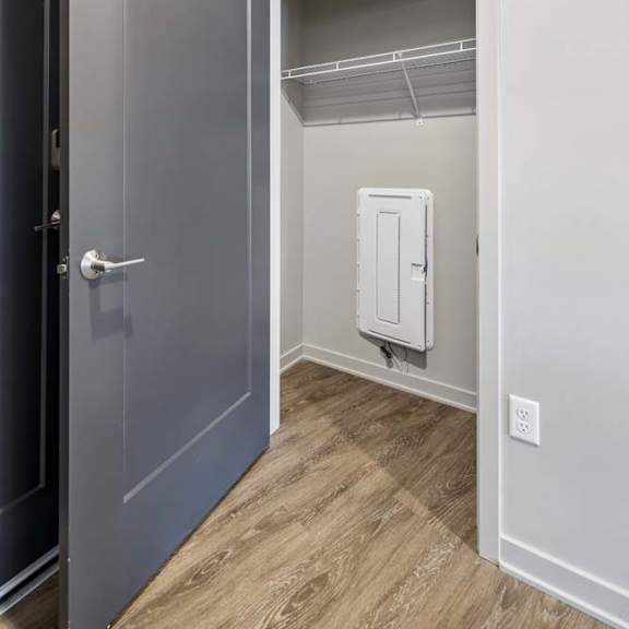 Thumbnail 17 of 17 Entryway storage closet with wire shelving, wood-look flooring, and easy access from the apartment foyer.