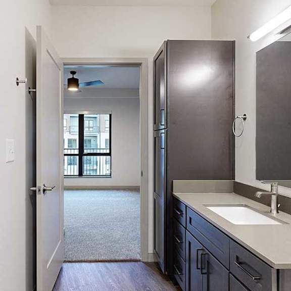 Thumbnail 27 of 29 a walk-through bathroom with an open door to the bedroom