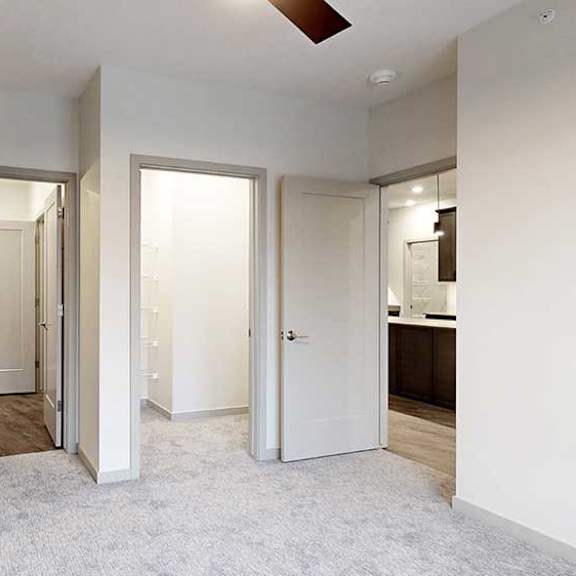 Thumbnail 22 of 29 a bedroom with carpeted flooring, a walk-in shower, and a walk-through bathroom