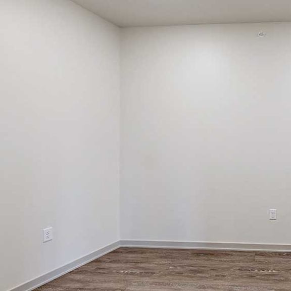Thumbnail 17 of 29 a den space with hardwood flooring and white walls