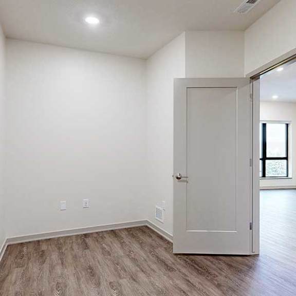 Thumbnail 19 of 29 a den space with hardwood flooring and a door to the living room
