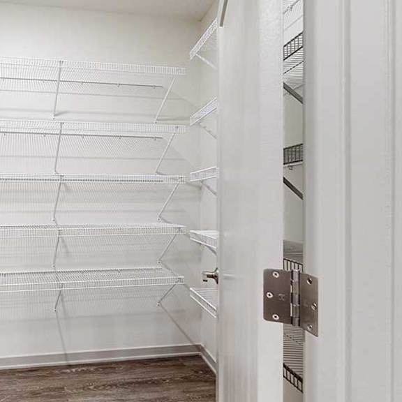 Thumbnail 5 of 29 a large walk-in panty with several rows of built-in shelves