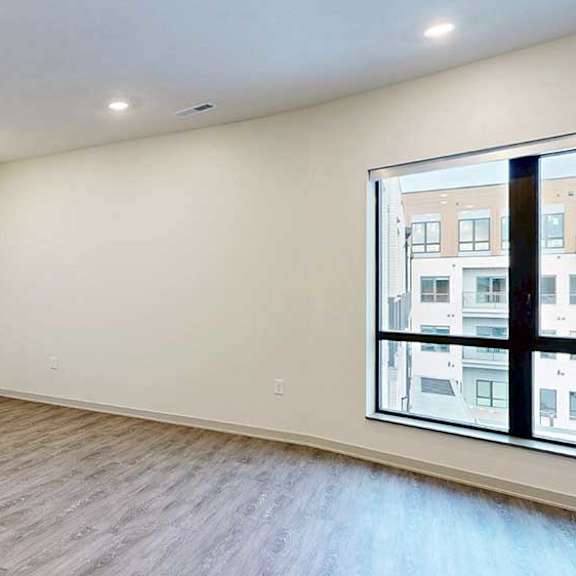 Thumbnail 9 of 29 a living room with hardwood flooring and a large window