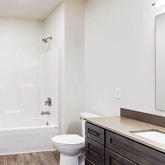 Thumbnail 23 of 28 a bathroom with a white shower tub