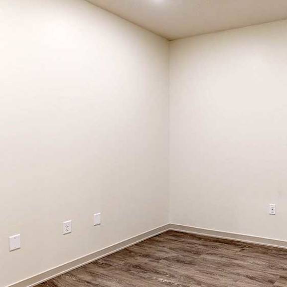 Thumbnail 16 of 28 a den space with hardwood floors and white walls