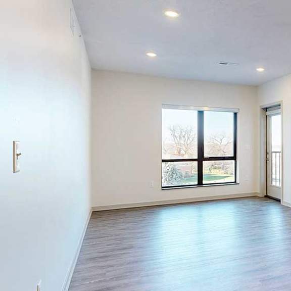 Thumbnail 9 of 28 a spacious living room with a large window to bring in plenty of natural light