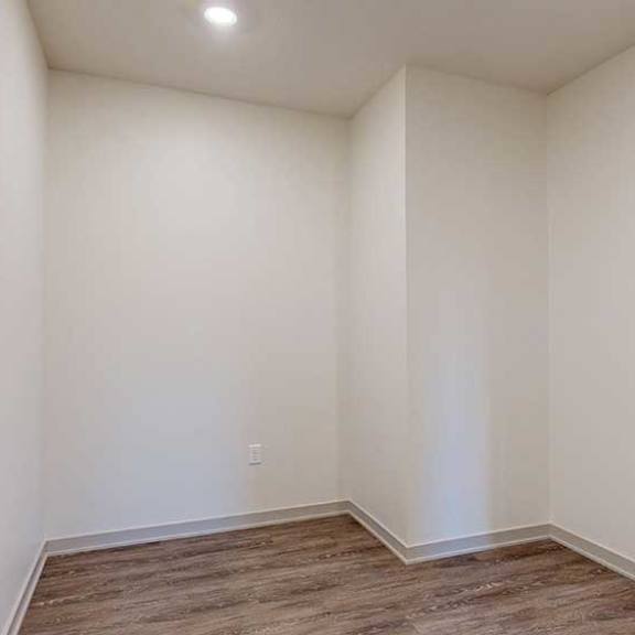 Thumbnail 16 of 24 A den space with hardwood-style flooring.