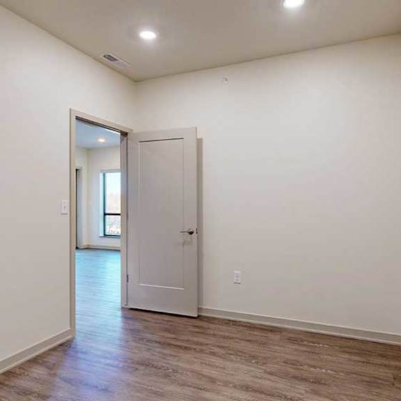 Thumbnail 17 of 24 A den space with hardwood-style flooring.