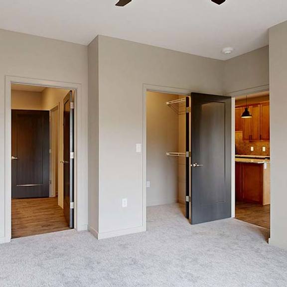 Thumbnail 64 of 84 A room with two doors and a carpeted floor.