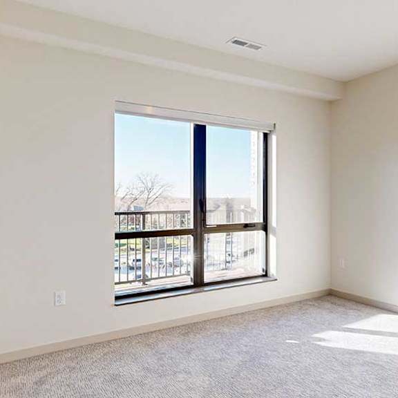 Thumbnail 29 of 30 a bedroom with carpeted flooring and a large window for natural light