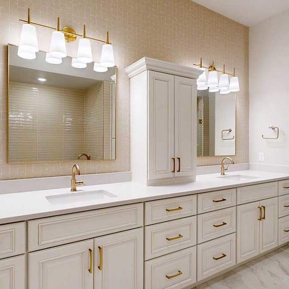 Thumbnail 23 of 31 Penthouse primary bathroom with dual vanities and custom built-in cabinetry