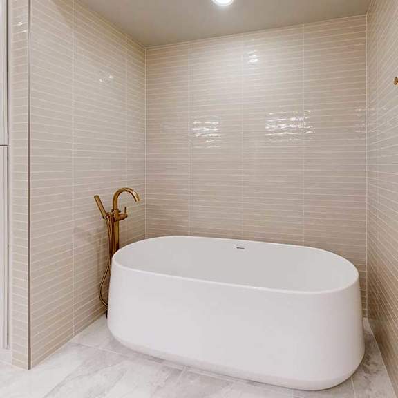 Thumbnail 22 of 31 Free standing soaking tub in nook with tiled surround in a penthouse apartment
