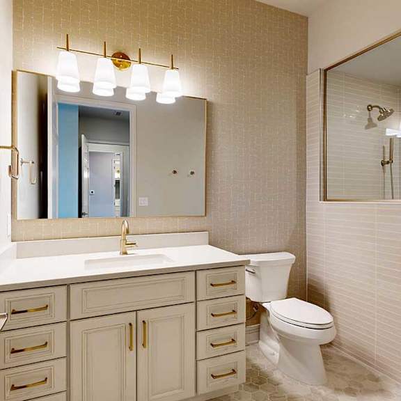 Thumbnail 29 of 31 Penthouse apartment bathroom with white vanity and titled walk-in shower